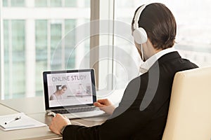 Man in headphones using online study course