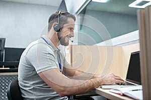Man in headphones working at laptop