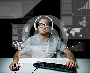 Man in headset with computer over virtual screens