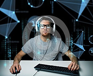 Man in headset hacking computer or programming