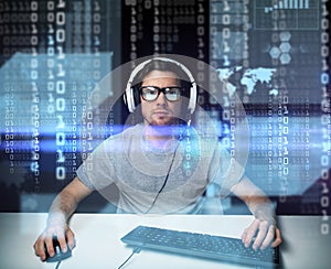 Man in headset hacking computer or programming