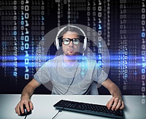 Man in headset hacking computer or programming