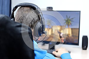 Man in headset playing a computer game on desktop PC