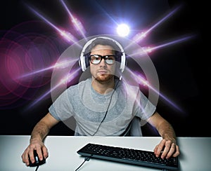 Man in headset playing computer video game