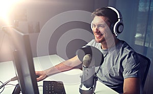 Man in headset playing computer video game at home