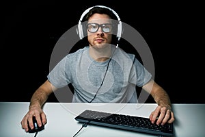 Man in headset playing computer video game