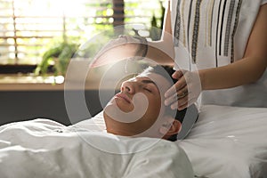 Man during healing session in room