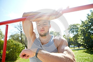 Man with heart-rate watch exercising outdoors