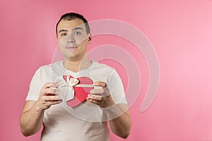 man with a heart-shaped gift box