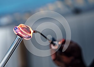 A Man Heating Glass With A Torch