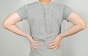 A man held her hand behind him with back pain. Healthcare concept