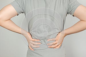 A man held her hand behind him with back pain. Healthcare concept