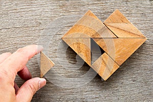 Man held piece of tangram puzzle to fulfill the heart shape