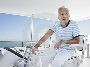 Man At The Helm Of Luxury Yacht