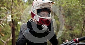 Man, helmet and bike in forest to prepare with safety for journey, race or travel by trees in nature. Person, outdoor