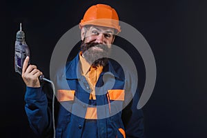 Man in helmet, builder with building equipment and hardhat. Safety helmet. Renovation. Man in hardhat. Heavy work