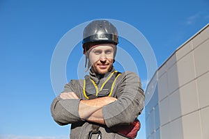 The man in the helmet confidently looks at the camera