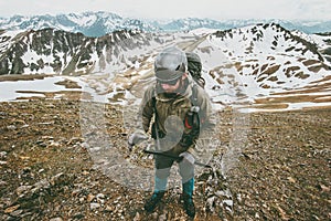 Man with helmet and ice axe climbing in mountains