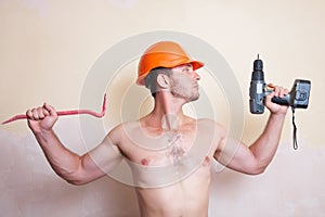 Man in helmet with a screwdriver and crowbar