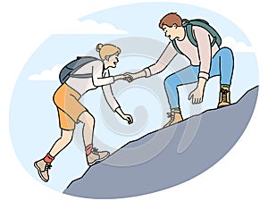 Man help female friend hiking
