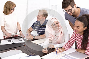 Man helping his freinds to make the language tasks