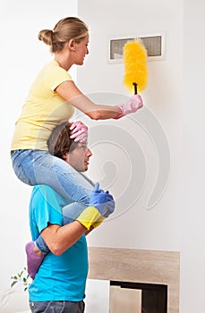 Man helping his wife in cleaning