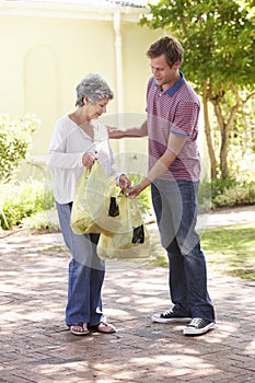 Man Helping Senior Woman With Shopping