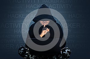 Computer hacker stealing data from a laptop