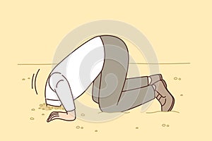 Man hides head in sand like ostrich from proverb, for concept of denial of problems and cowardice