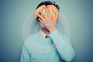 Man hiding behind bananas