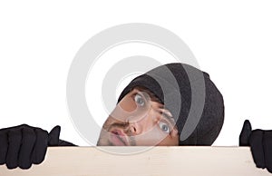 Man hiding behind board