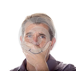 Man hiding his true emotions by covering his mouth with a fake s