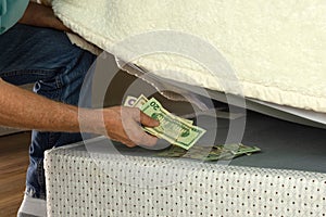 Man hiding money under his mattress because he doesn`t trust banks