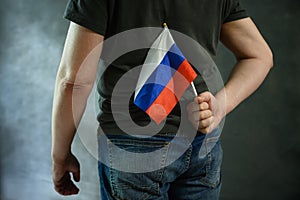 Man hiding Russian flag behind his back