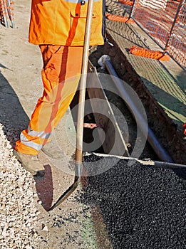 man with high visibility clothing while working for laying techn