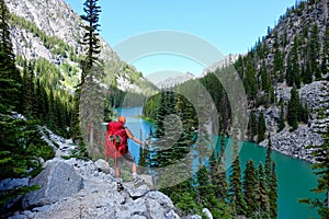 Man hiker by alpine lake.