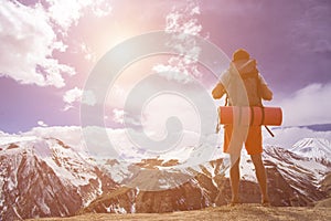 Man hiker greeting rich nature on the top of mountain