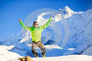 Man hiker happy jump in winter mountains