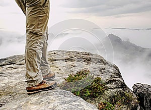 Man hiker legs with windproof trousers and hiking boots