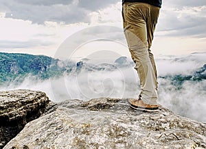 Man hiker legs with windproof trousers and hiking boots