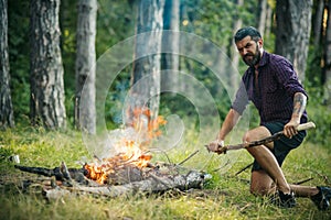 Man hiker make fire in forest