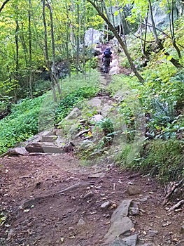 Man hikes steep stone steps up Poke O Moonshine Trail