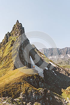 Man hiking alone standing on mountain cliff edge adventure active