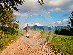 Man hiking with backpack Carpathian Mountains on scenic view Travel Lifestyle wanderlust adventure outdoor into the wild