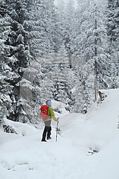 Man hiking in beautiful winter mountain