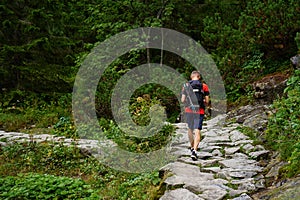 Man hiking in forest with backpack