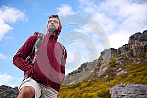 Man, hiking and mountain with bag in nature, Germany trail for conservation. Active, male person on adventure for health
