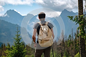 Man hiking at mountains with heavy backpack