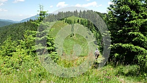 Man hiking in the mountains. Hiker on a trail in the Carpathian Mountains, Romania.