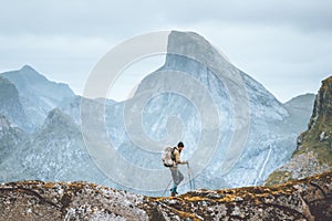 Man hiking in mountains traveling solo with backpack outdoor active vacations in Norway
